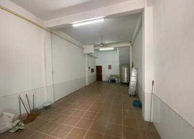 Spacious empty room with high ceiling and tiled floor
