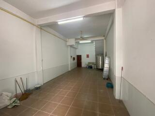 Spacious empty room with high ceiling and tiled floor