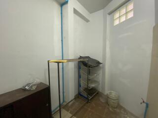 Small utility room with shelves and minimal furnishings