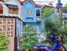 Exterior view of a colorful townhouse with a blue facade