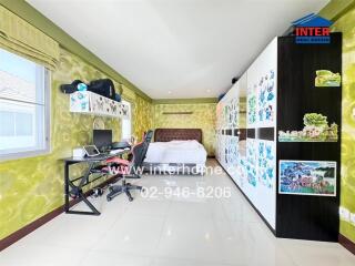 Spacious bedroom with work desk, wardrobe, and large window