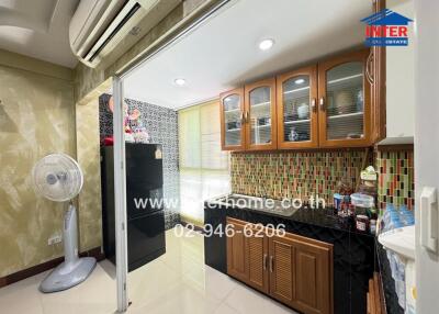 Modern kitchen with wooden cabinets, tile backsplash, and appliances