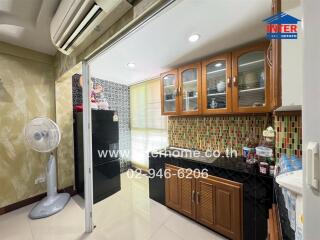 Modern kitchen with wooden cabinets, tile backsplash, and appliances