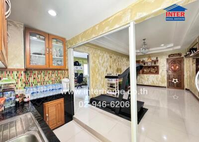 Kitchen and adjoining exercise area with modern fixtures and decor