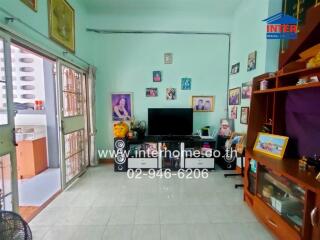 Living room with a TV, decorations, and various furniture