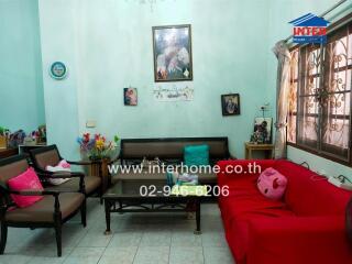 Cozy living room with red and brown seating and decor