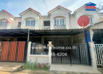 Two-story townhouse with front yard and gated entrance