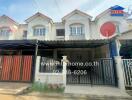 Two-story townhouse with front yard and gated entrance