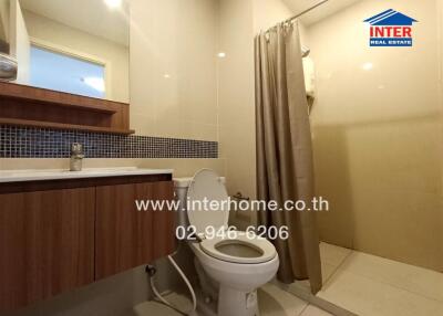 Bathroom with shower, toilet, sink and mirror