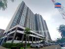 High-rise residential building with parking lot and landscaped area