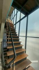 Modern staircase with wooden steps and metal railing