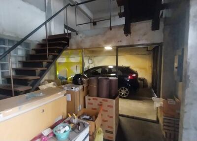 Large garage space with car and storage items