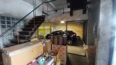 Large garage space with car and storage items