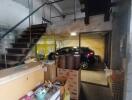 Large garage space with car and storage items