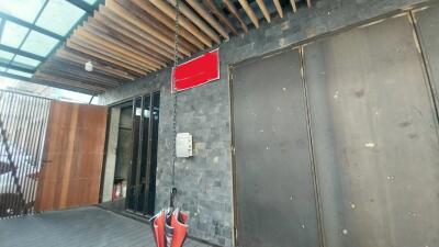 Entrance of the building with transparent roof and wooden ceiling accents