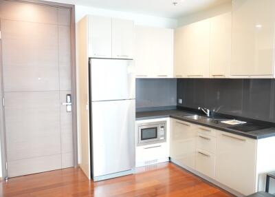 Modern kitchen with stainless steel appliances and wooden flooring