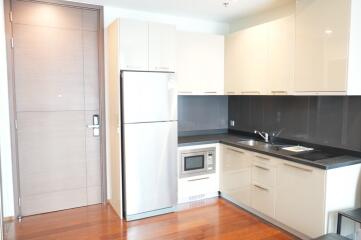 Modern kitchen with stainless steel appliances and wooden flooring