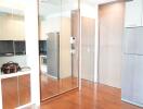 Modern kitchen with wooden flooring and mirrored cabinets