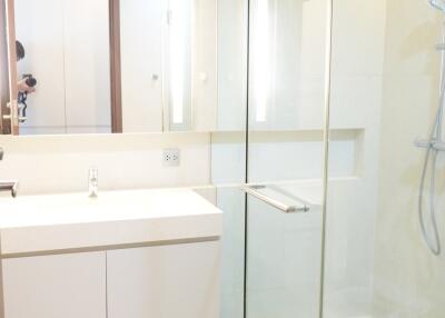 Modern bathroom with a glass-enclosed shower and a large mirror