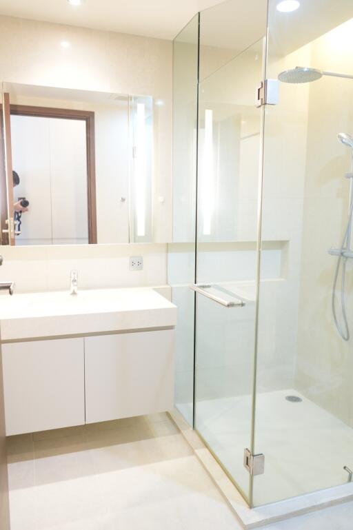 Modern bathroom with a glass-enclosed shower and a large mirror