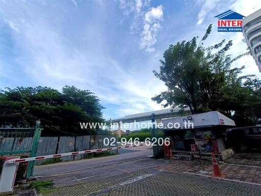 Outdoor view of property entrance with gate and greenery