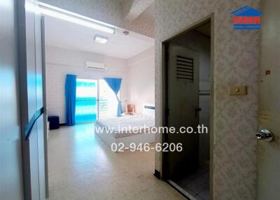Spacious bedroom with large bed, air conditioning, and balcony access.