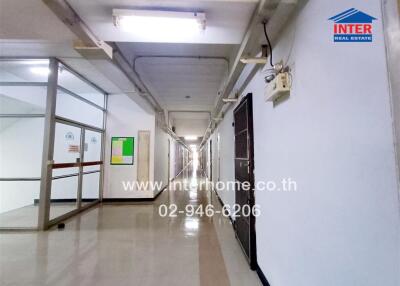 Hallway of a building with multiple doors and overhead lighting