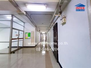 Hallway of a building with multiple doors and overhead lighting