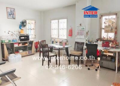 Spacious kitchen area with dining table and appliances