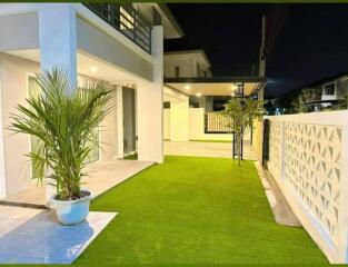 Outdoor area of a modern residential building with a garden