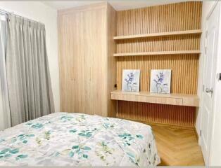 Bedroom with built-in wooden cabinetry and wall decor