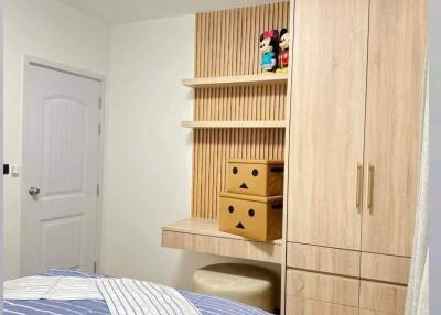 Cozy bedroom with built-in wardrobe and decorative shelving
