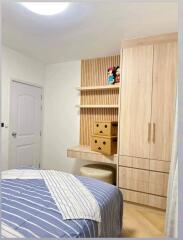 Cozy bedroom with built-in wardrobe and decorative shelving