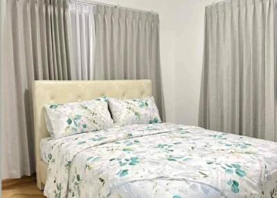 Bright bedroom with double bed and floral bedding
