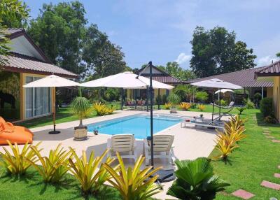 Backyard with pool and lounge chairs