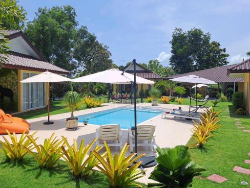 Backyard with pool and lounge chairs