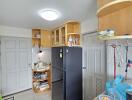 Modern kitchen with black refrigerator and wooden cabinets