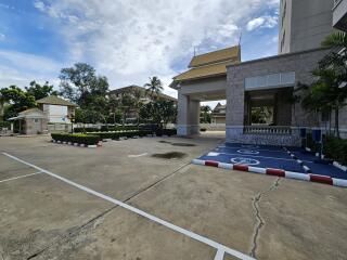 Exterior view of the property showing parking area and surrounding buildings