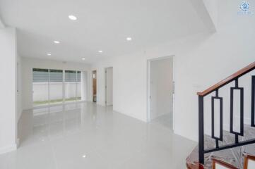 Spacious living room with white walls and ample natural light