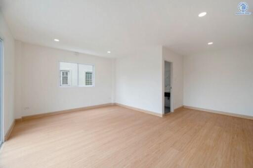 Spacious and bright main living area with windows and wooden flooring