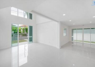 Spacious living room with large windows and ample natural light