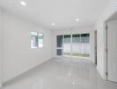 Minimalist living room with large windows and tiled floor