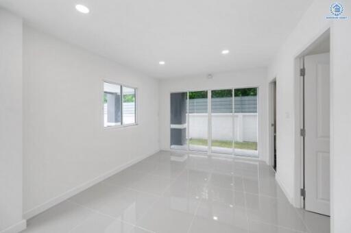 Minimalist living room with large windows and tiled floor