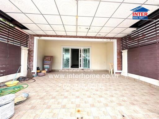 Outdoor covered patio area with sliding glass doors