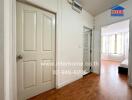 Modern hallway with wooden flooring and a glimpse into a bright bedroom