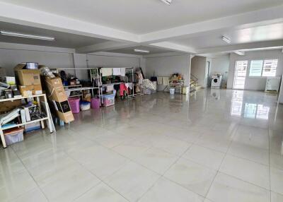 Spacious basement/storage area with shelving units and utility room