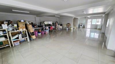 Spacious basement/storage area with shelving units and utility room