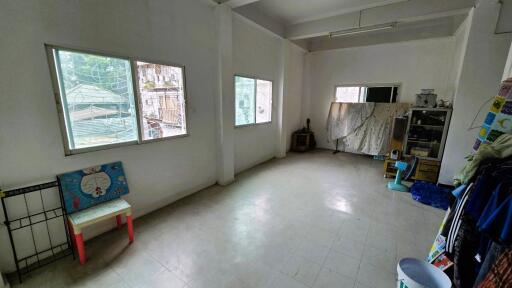spacious room with multiple windows and minimal furnishings
