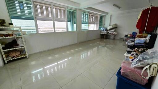 Spacious tiled room with storage and ample natural light