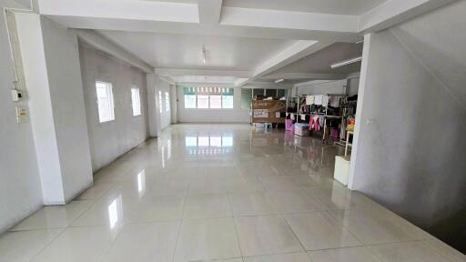 Spacious open-plan living area with tiled floors and large windows